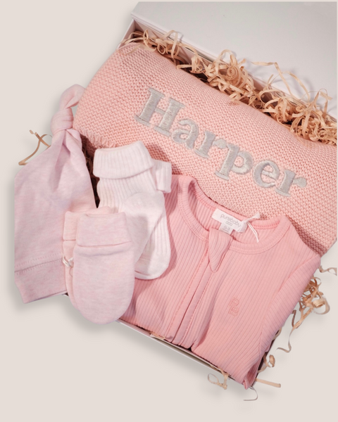 colour:dusty-rose | Close-up of dusty rose welcome baby gift box with personalised Harper knit blanket