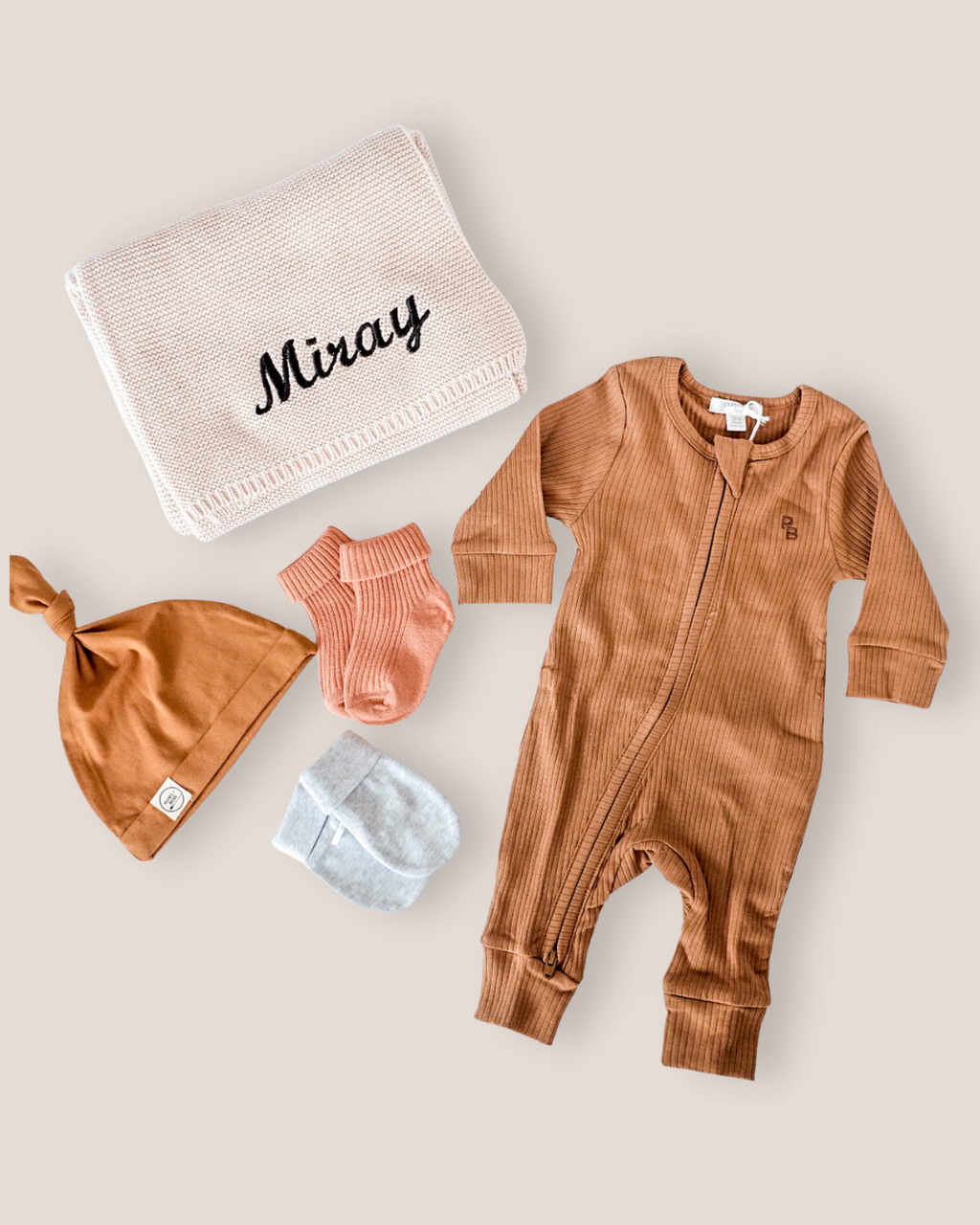 colour:chocolate | Flat-lay of personalised chocolate welcome baby gift set