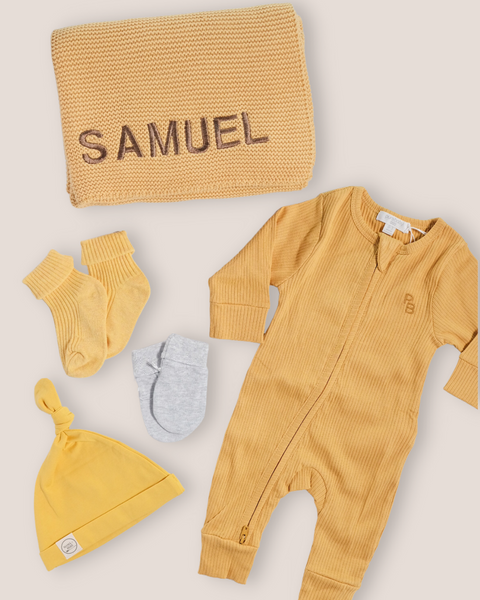 colour:golden | Flat-lay of personalised golden welcome baby gift set