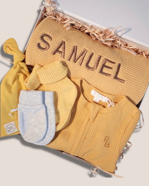 colour:golden | Close-up of golden mustard welcome baby gift box with personalised SAMUEL knit blanket