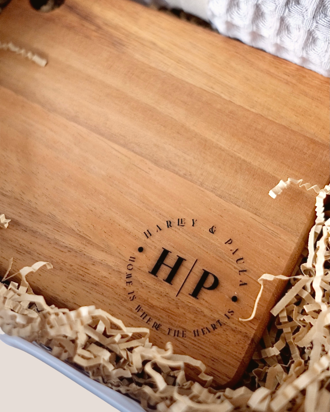 Close-up of laser engraved cheeseboard with couple name Harvey and Paula monogram H|P – personalised housewarming gift Australia